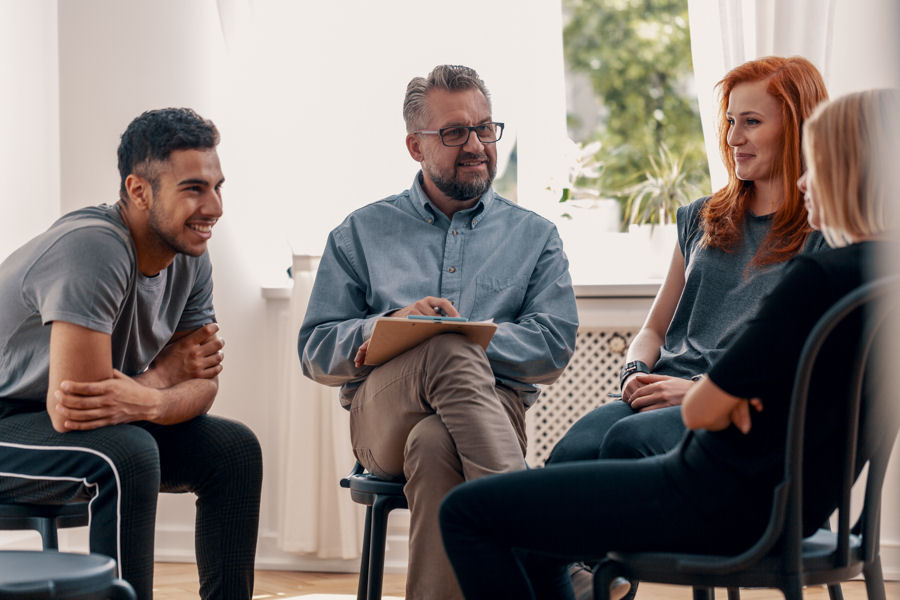 group of friends smiling and laughing after receiving treatment for mental health