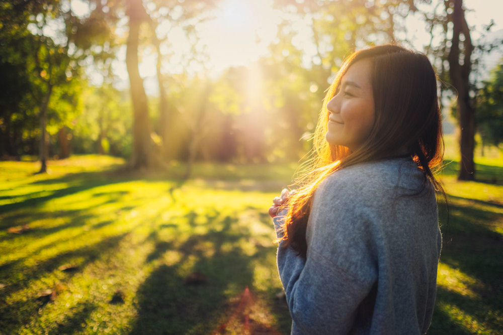 woman smiling outside who is in a mental health treatment program