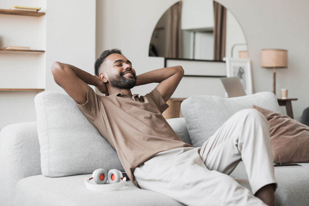 man relaxing on white couch