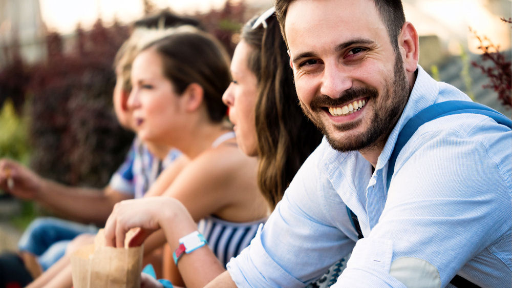 man sitting outside with friends in recovery